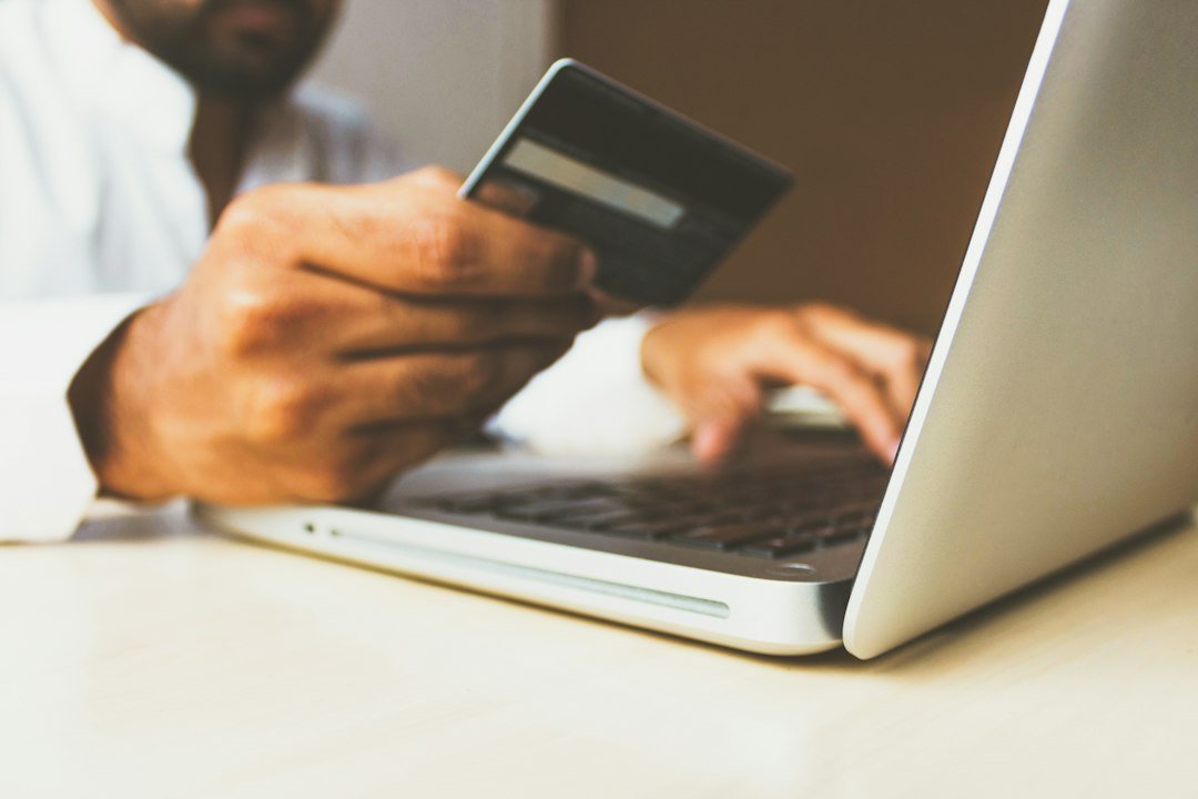Person holding a credit card while paying online